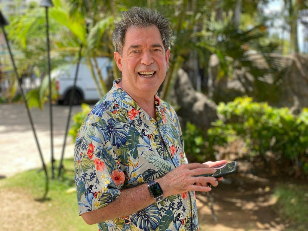 man happy on vacation in Hawaii wearing his tropical shirt